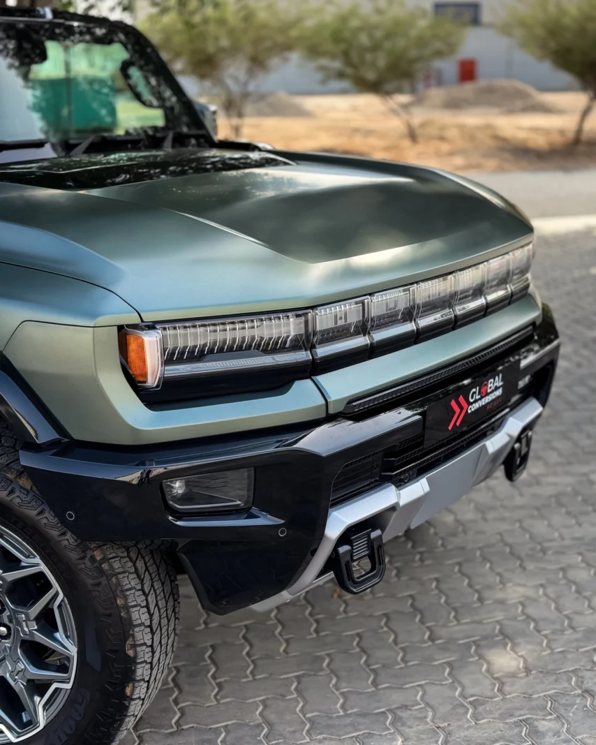 Close-up view of GMC Hummer EV rear lights and grille design with distinctive LED headlight details